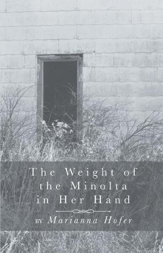 Cover image for The Weight of the Minolta in Her Hand
