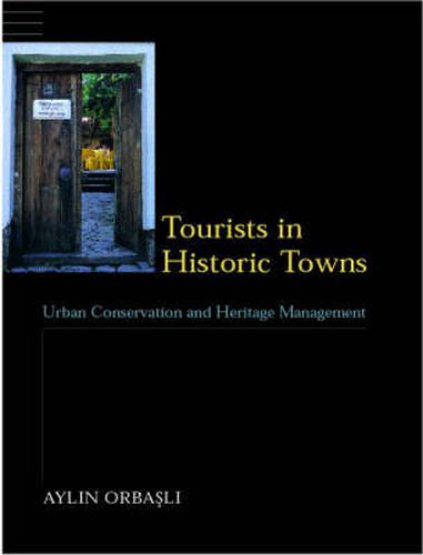 Cover image for Tourists in Historic Towns: Urban Conservation and Heritage Management