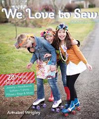 Cover image for We Love to Sew: 28 Pretty Things to Make: Jewelry, Headbands, Softies, T-Shirts, Pillows, Bags & More